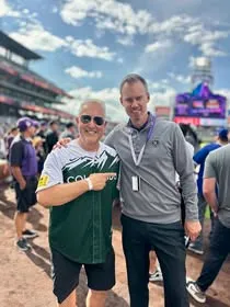 Two supporters standing together at a baseball stadium